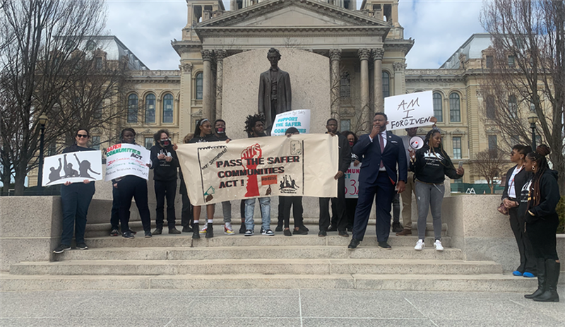 Rep. Kam Buckner, D-Chicago, joins members of the Workers Center for Racial Justice outside the Illinois State Capitol Wednesday in support of a wage subsidy program for individuals recently released from incarceration.