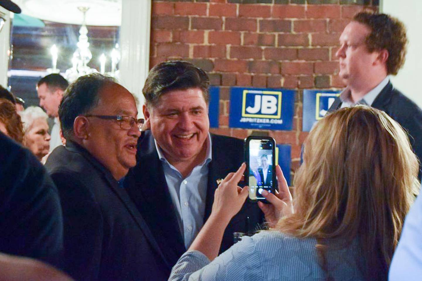 Gov. JB Pritzker takes a picture with Mike Lopez, mayor of nearby Jerome, after announcing his reelection campaign in Springfield on Thursday, June 26, 2025.