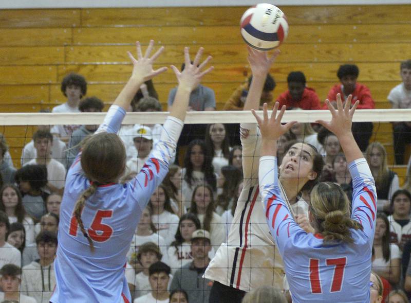 Streator’s Alexa Jacobs prepares a tip while Ottawa’s Addison Duggan and Olivia Evola prepare the block  in the second match Thursday at Streator.