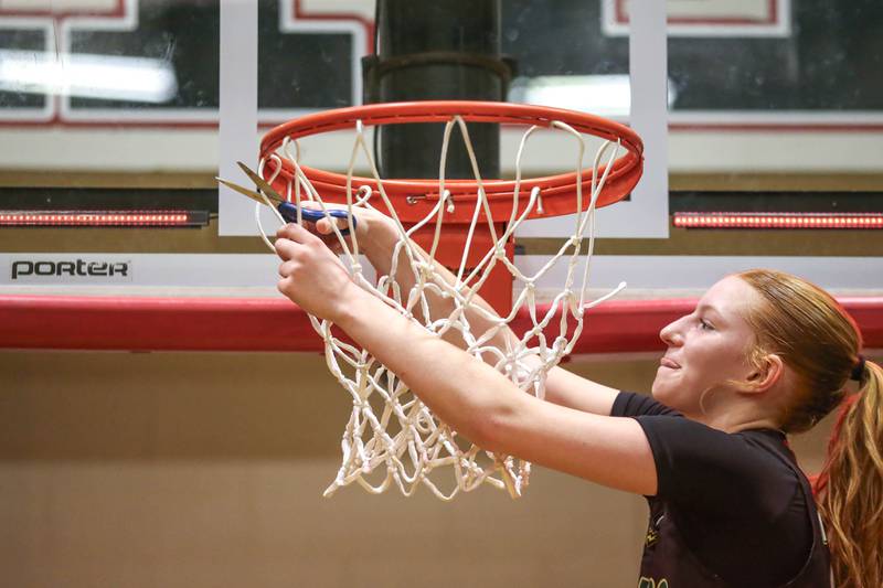 Waubonsie Valley's Lily Newton (23) cuts down the net after their victory over Benet in their Class 4A Bolingbrook Sectional final basketball game between Waubonsie Valley at Benet. Feb 27, 2025 in Bolingbrook.