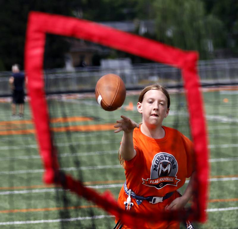 Jordyn Carpenter throws the football during the Chicago Bears Mini Monsters Flag Football Camp on Wednesday, July 16, 2025. at McCracken Field in McHenry.