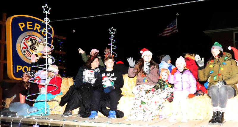 Peru Police Department rides  in the Christmas parade during the annual Christmas Parade on Saturday, Dec. 7, 2024 on Peoria Street in Peru.