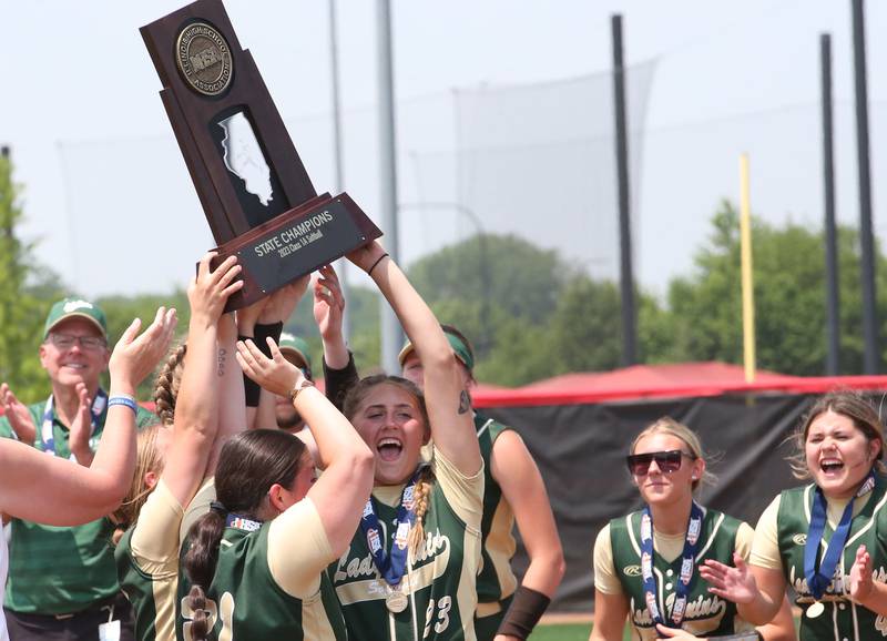Members of the St. Bede softball team hoist the Class 1A State championship trophy after defeating Illini Bluffs on Saturday, June 3, 2023 at the Louisville Slugger Sports Complex in Peoria.