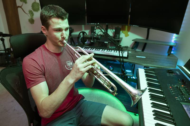 Newman High School student Maxwell DeForest plays a trumpet in the music room of his Dixon home Thursday, June 8, 2023. DeForest will be studying trumpet performance at the New England Conservatory in Boston this fall.