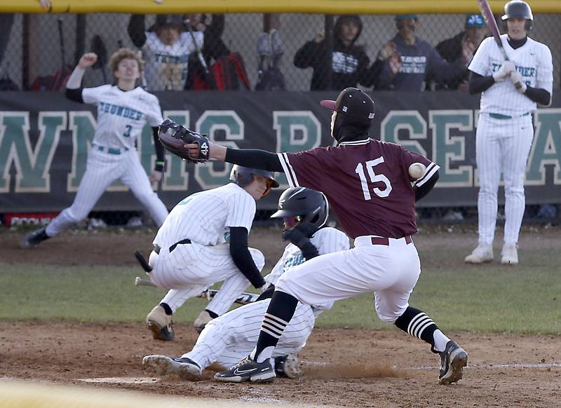 Woodstock North’s Sean Pigliacelli slides into home plate as the throw gets past Marengo’s Cody Stallings to tie the game during a Kishwaukee River Conference baseball game Wednesday, April 25, 2023, at Woodstock North High School.