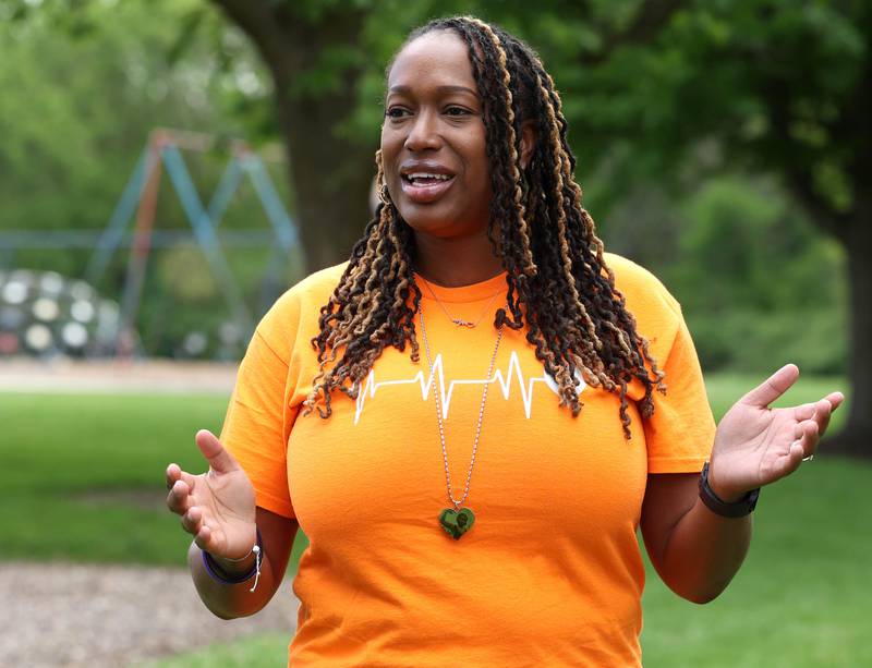 Andrea Elion, mother of Ezra Hill Jr. talks Monday, May 12, 2025, about him as she stands next to a tree and rock garden at Tyler Elementary School, where he attended, that is dedicated to his memory. Hill was murdered in 2019 in Harvey, and the Fifth Annual Ezra Hill Jr. Memorial Rock Painting event will be held on June 7 at the school in DeKalb.