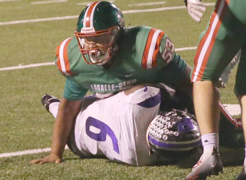 L-P's Nolan Glynn brings down Plano's Waleed Johnson on Friday, Sept. 15, 2023 at Howard Fellows Stadium.