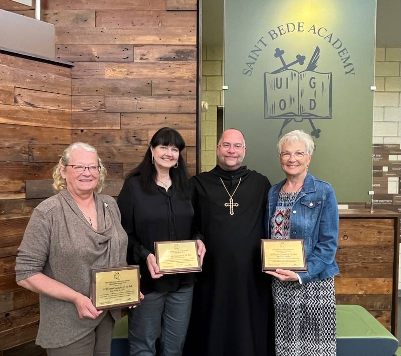 The St. Bede Alumni Association presented a special award Sunday, Oct. 1, 2023, to honor all women graduates of St. Bede in honor of the 50th anniversary of when St. Bede became coeducational. Accepting the award from Abbot Michael Calhoun, OSB 1989 (second from right)  where the first female graduates of 1973 Lissa (Harrison) Balda, Debb (Garncarz) Ladgenski and Rosemary (Kunkel) Wall.