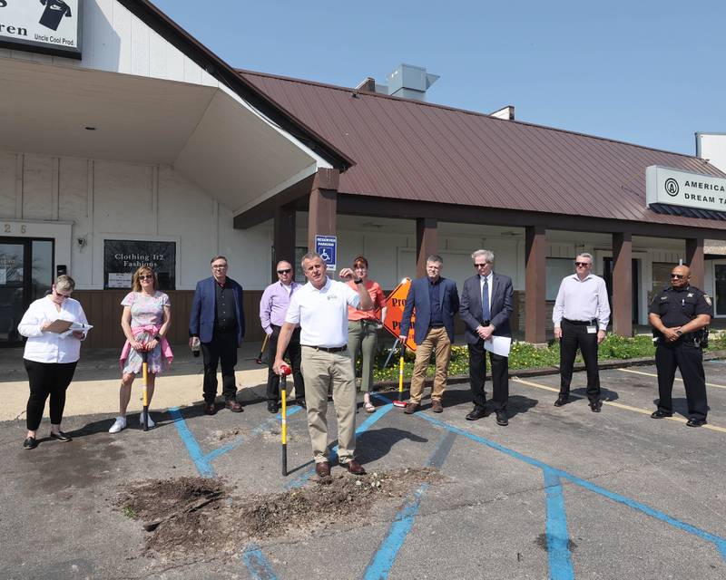 DeKalb Mayor Cohen Barnes, flanked by members of the DeKalb City Council and other city officials, speaks during a special meeting of the council Monday, May 9, 2022, in the parking lot of the former Hillcrest Shopping Center. The meeting was held to kick off the demolition process of the strip mall on Hillcrest Drive which will begin Tuesday morning.