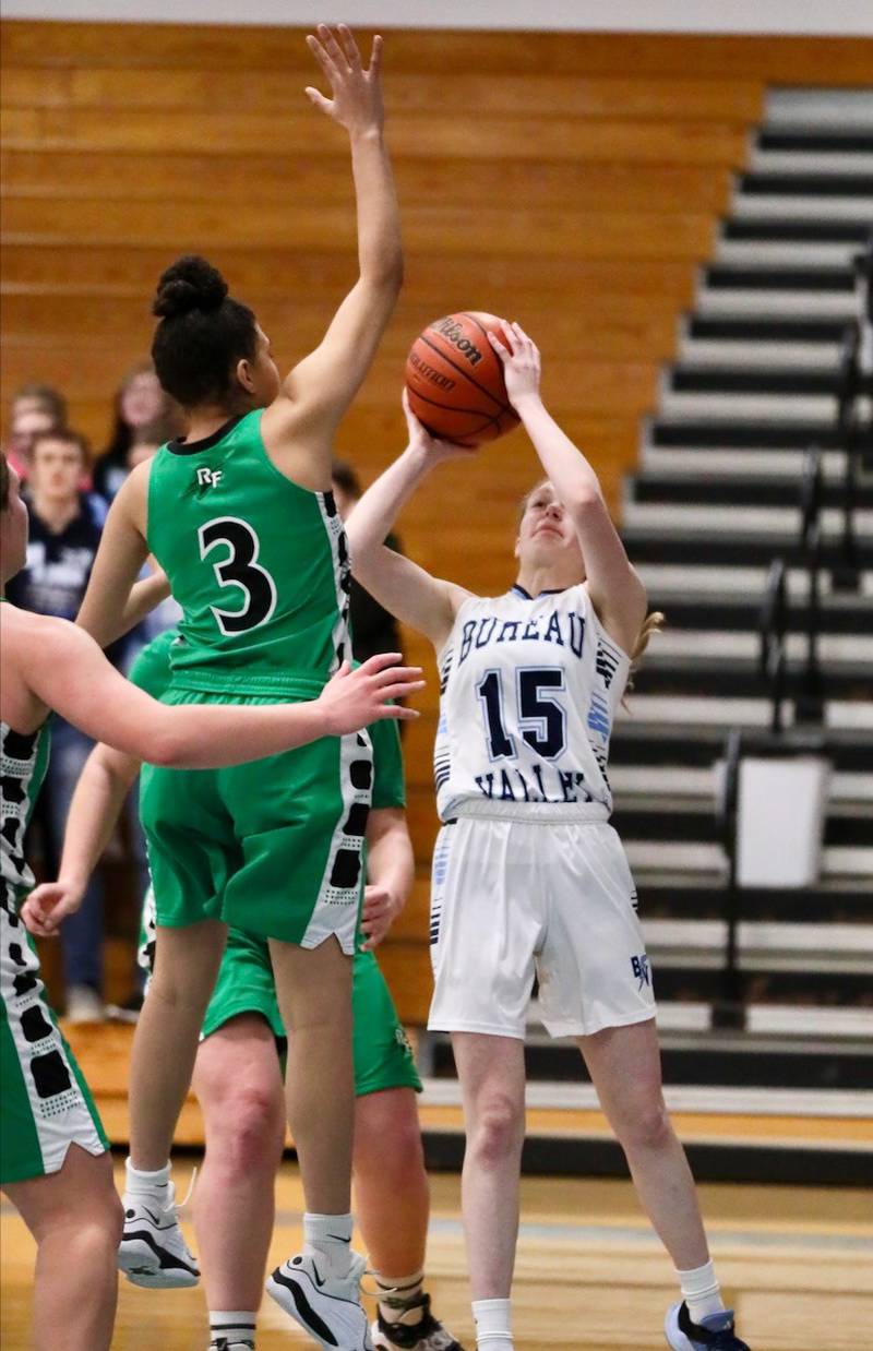 Bureau Valley's Taylor Neuhalfen shoots against Rock Falls' Autumn Weathersby in Saturday's regional game at the Storm Cellar.