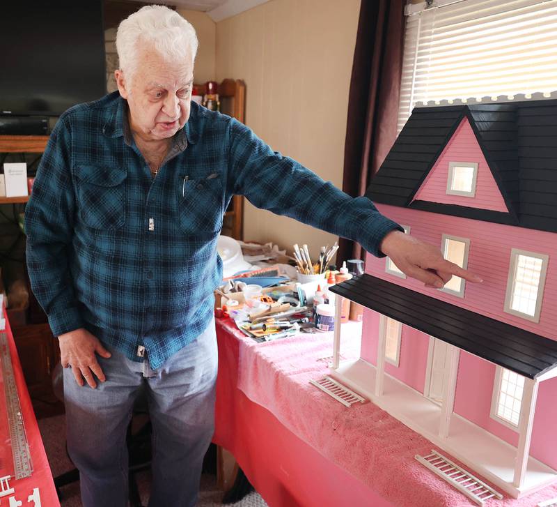 Sycamore resident Lee Newtson points out some features Thursday, March 24, 2022, at his home, on the doll house he has built that will be raffled off as a fundraiser to benefit Ukraine.