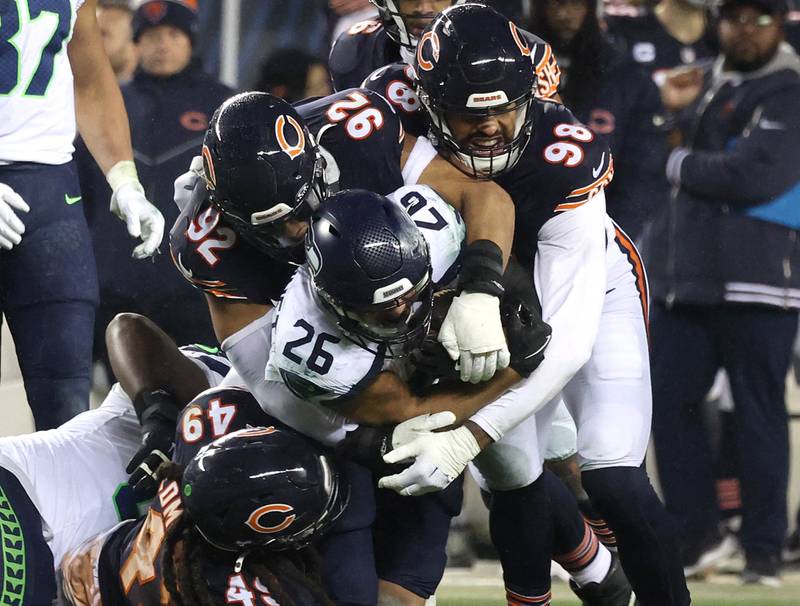 Members of the Chicago Bears defense swarm to tackle Seattle Seahawks running back Zach Charbonnet during their game Sunday, Dec. 26, 2024, at Soldier Field in Chicago.