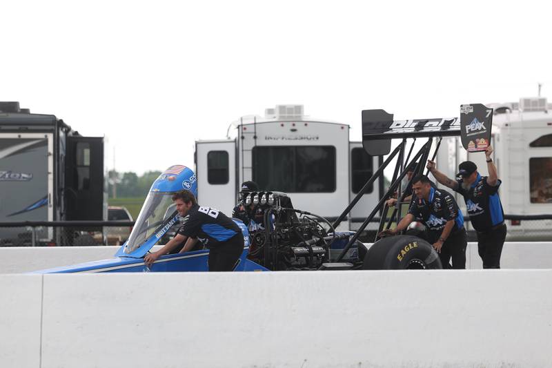 Team Blue DEF pushes Brittney Force’s car out on the track for a photo shoot in preparations for the NHRA Route 66 Nationals this weekend at Route 66 Raceway on Thursday, May 16, 2024 in Joliet.