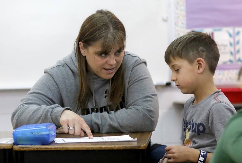 Zoki Russo, a third grade teacher at Sleepy Hollow Elementary School, works with a student as she teaches her class.