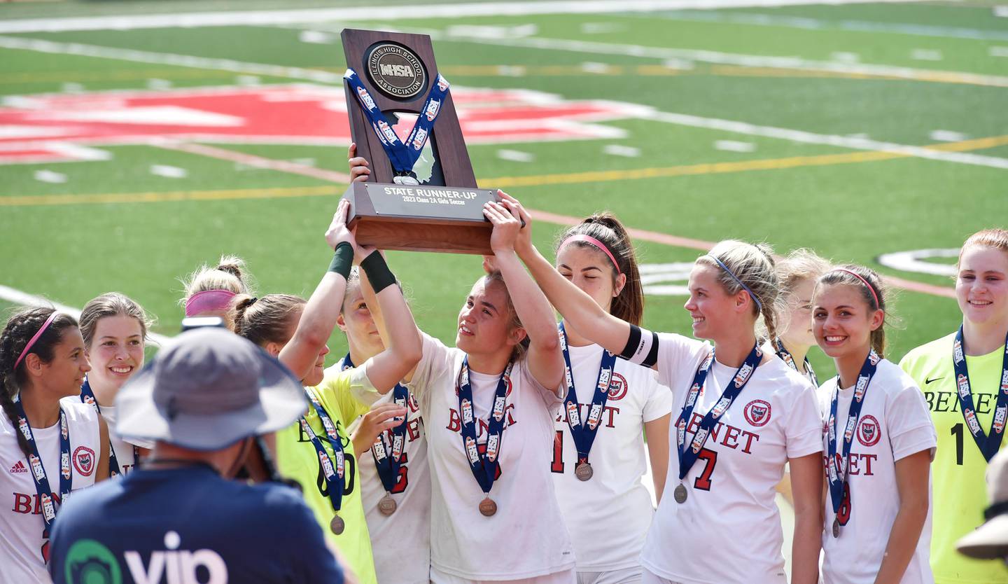 Benet Academy holds their second-place trophy after losing to Glenwood in the IHSA girls Class 2A state soccer championship game at North Central College in Naperville on Saturday, June 3, 2023.