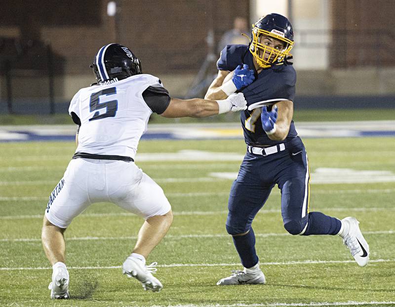 Sterling’s Andre Klaver tries to get way from St. Francis’ Domenic Beres Friday, Sept. 1, 2023 at Sterling High School.