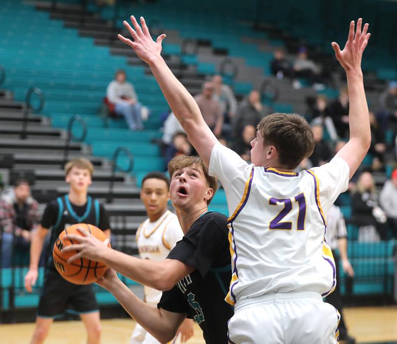 Woodstock North's AJ Cohen drives to the basket against Hononegah’s Jace Brady during the 2025 Hoops for Healing tournament basketball game on Wednesday, Nov. 26, 2025, at Woodstock North High School.