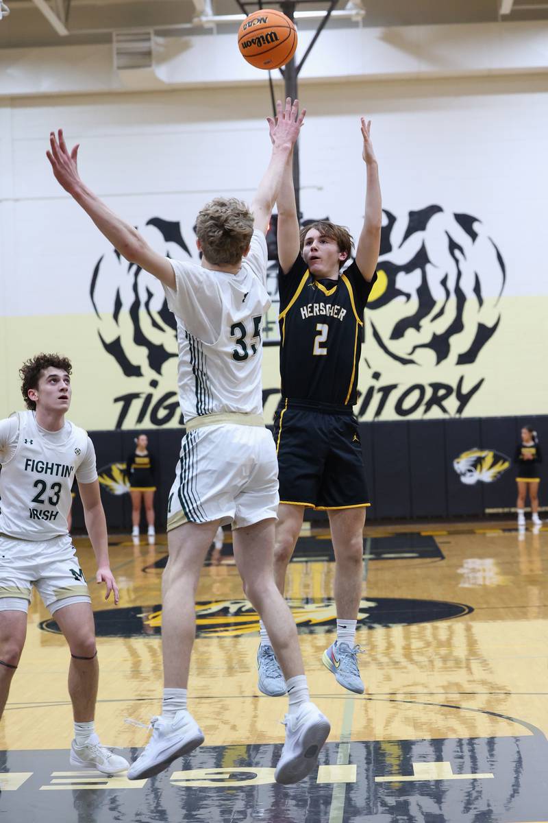 Herscher's Austin Buckley shoots over Bishop McNamara's Richie Darr during Bishop McNamara's 71-42 victory in the IHSA Class 2A Herscher Regional semifinal on Wednesday, Feb. 25, 2026.
