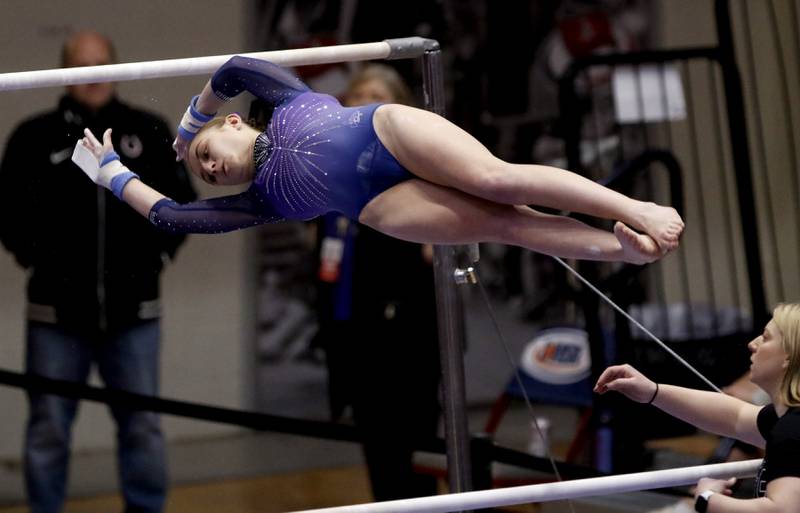 Downers Grove's Allison Palansky competes in the preliminary round of the uneven parallel bars on Friday, Feb. 21, 2025, during the IHSA Girls State Final Gymnastics Meet at Palatine High School.
