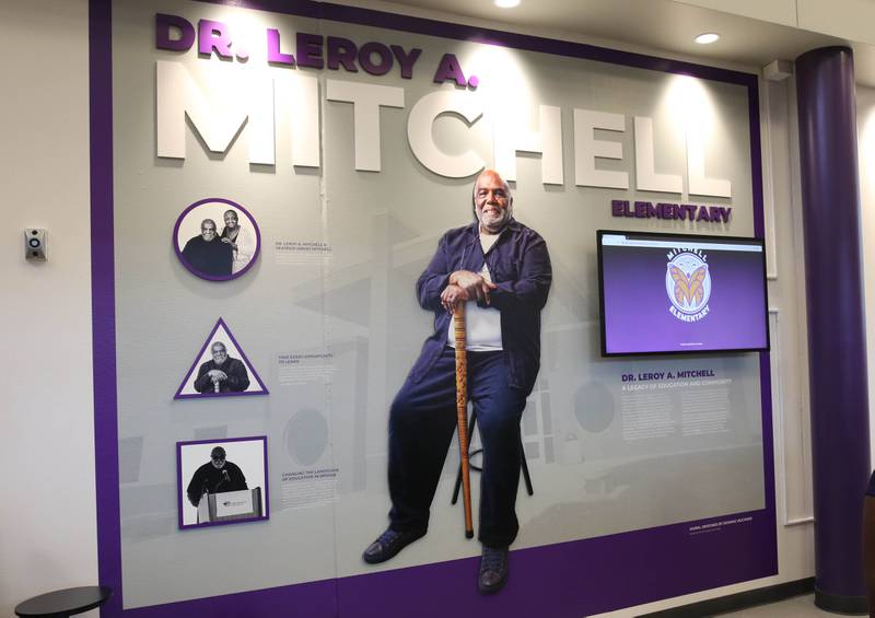 The informational mural which tells the story of Leroy Mitchell in the entryway at the new Mitchell Elementary School Friday, Aug. 8, 2025, during the grand opening celebration at the school in DeKalb.