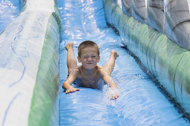 Sawyer Venier, 8, goes head first down the water slide Thursday, June 15, 2023 during Dixon Park District’s SPARK Camp. Thursday marked the final day of the event for kids ages 7-9. Another camp is scheduled in July.