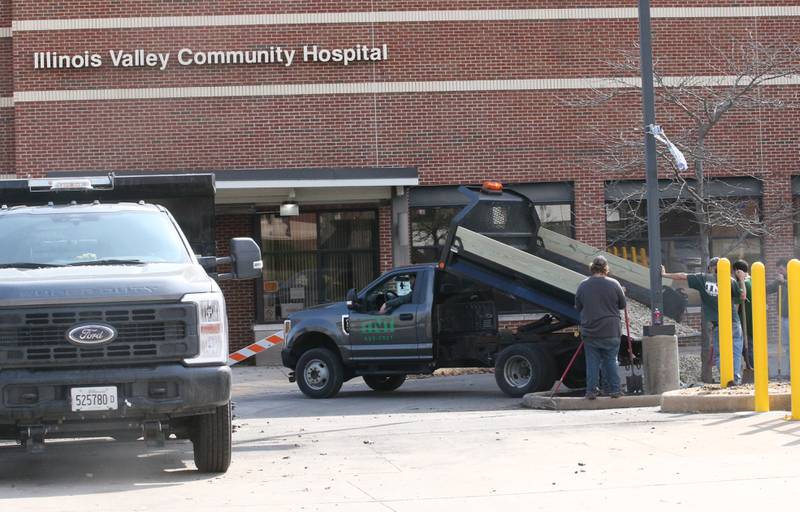 Workers with TNT Lawn and Snow dump rocks for new landscaping on the main entrance of the former St. Margaret's Peru and Illinois Valley Community Hospital on Wednesday, March 13, 2024 in Peru. OSF Healthcare will open the Emergency department on Sunday, April 7, at 7a.m.