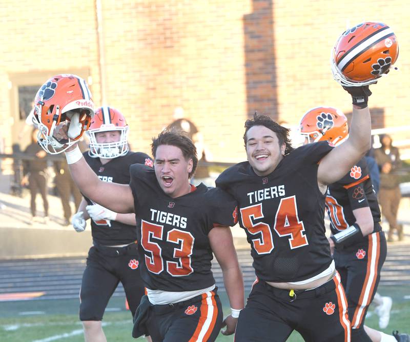 Byron linemen Dalton Norris (53) and Braiden Hammes (54) celebrate after the Tiger's 28-6 win over Elmhurst IC Catholic during 3A quarterfinal action at Byron High School on Saturday, Nov. 15, 2025.