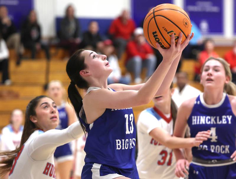 Hinckley-Big Rock's Mia Cotton gets a reverse layup in front of Marian Central's Jasmine Blades Monday, Feb. 16, 2026, during their regional semifinal game at Hinckley-Big Rock High School.
