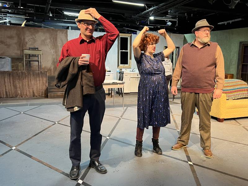 Michael Carlson [left], Lori Brubaker [middle] and Scott Mueller [right] stand on stage during a rehearsal for "A Christmas Story" at the Stage Coach Players theatre on Dec. 1, 2022.