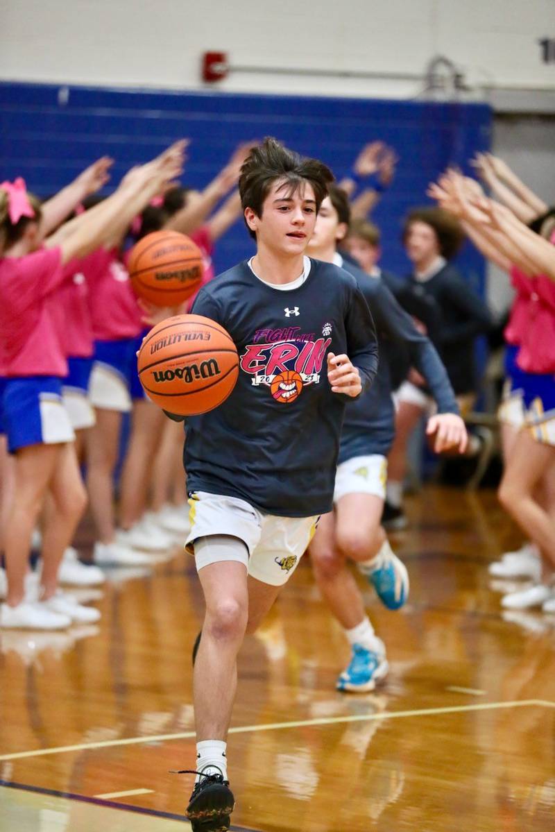 Logan eighth-grader Jack Oester leads the Lions out to the floor for Tuesday's Fight like Erin Night against LaSalle Lincoln at Prouty Gym.