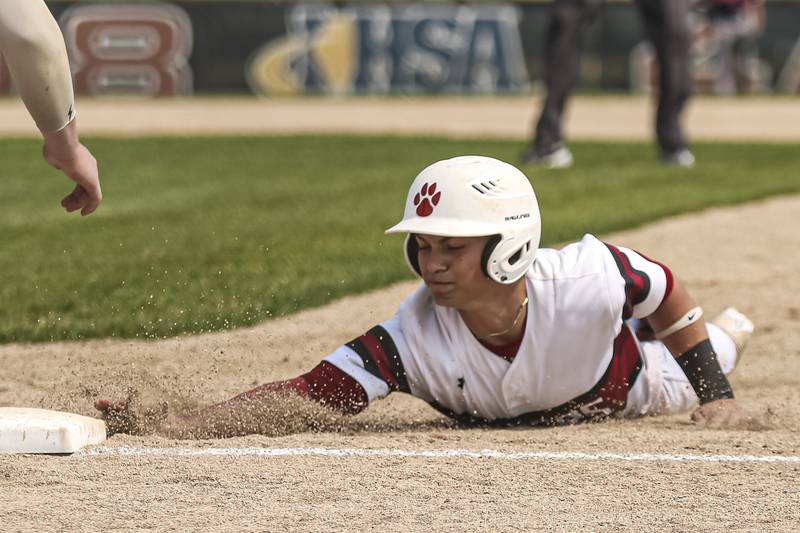 Plainfield North's Luca Agne (12) dives back to second during a pick off attempt in the Class 4A Plainfield North Regional final baseball game between Oswego at Plainfield North. Saturday, May 31, 2025 in Plainfield.