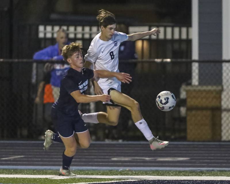 Downers Grover North's Braeden Page (8) fights off the defense of Downers Grove South's Ryan Ording (6)  during soccer match between Downers Grove North at Downers Grove South. Oct 2, 2025.