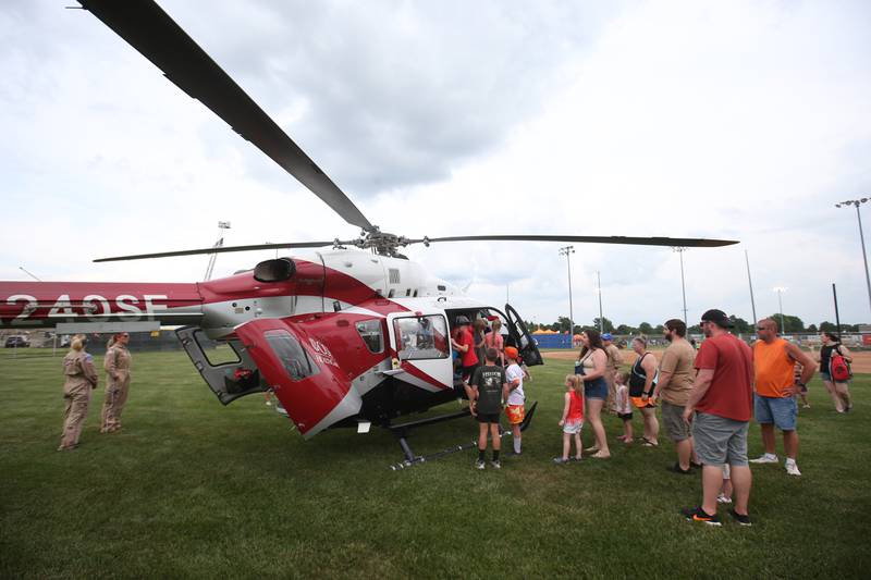 Fans tour OSF Lifeflight helicopter during the Illinois Valley Pistol Shrimp First Responder Night on Tuesday, June 17, 2025 at Schweickert Stadium in Peru.