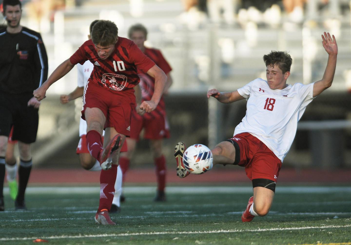 Naperville Central’s Chase Adams takes a shot as Hinsdale Central’s Austen Szurgot tries to stop him in the Class 3A East Aurora supersectional boys soccer game on Tuesday, November 1, 2022.