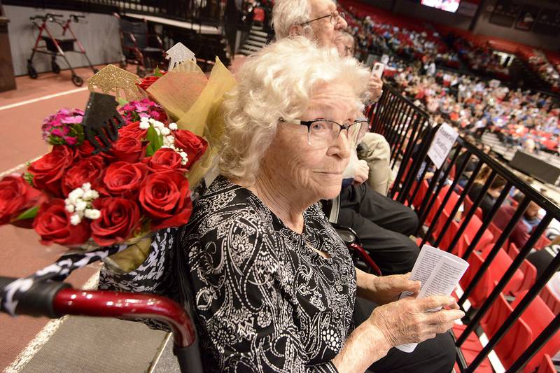 Charged with holding onto the flowers, Julia Machart watches the ceremony right after her triplet great-grandchildren; Connor, Natalie and Ryan Keefe received their diplomas during Yorkville High School's class of 2022 graduation ceremony at the NIU Convocation Center on Friday, May 20, 2022.