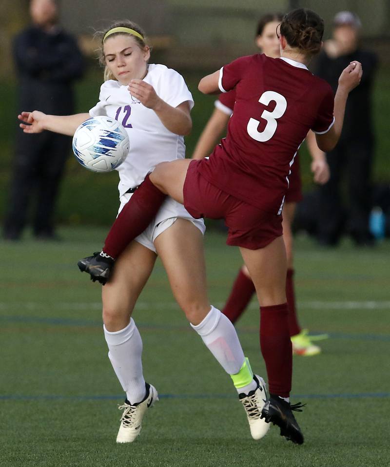 Hampshire's Amelia Ingebretsen battles Prairie Ridge's Violet Woodin for the ball during a Fox Valley Conference soccer game on Tuesday, April 16, 2024, at the MAC Athletic Complex in Crystal Lake.