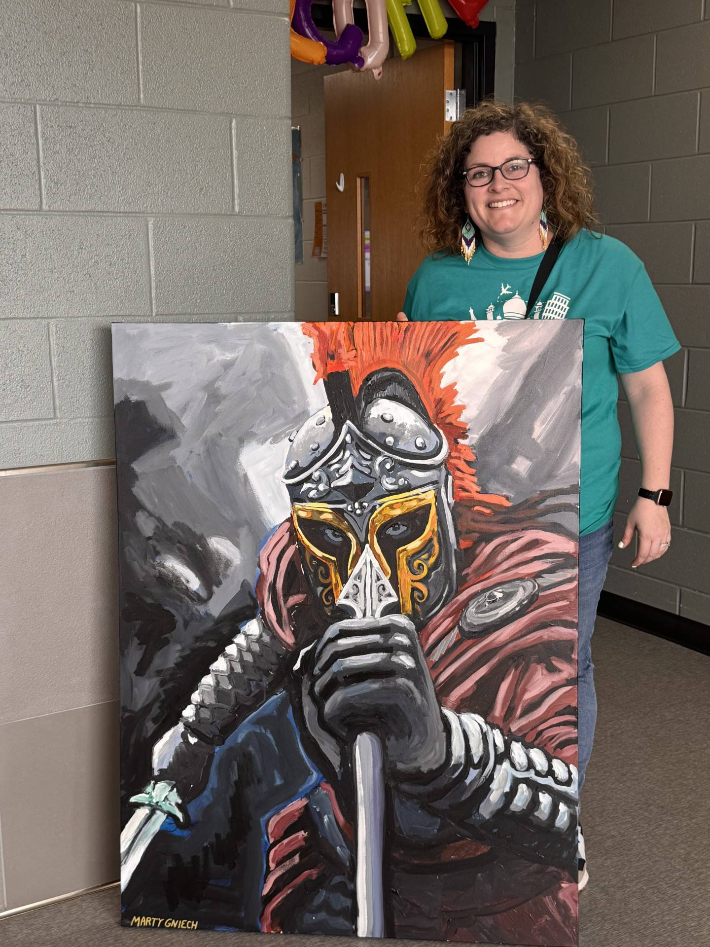 Kelsey Podgorski, McHenry High School District 156's assistant director of multilingual education, poses with student art created for the second-annual Multicultural Fair, held April 5 at McHenry High School Upper Campus.
