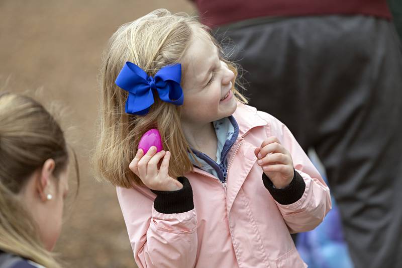 Natalie Schmidt, 4, or Oregon shakes, listens and guesses the hidden treasure Saturday, March 30, 2024 while hunting for eggs in Polo.