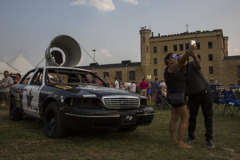 Margie and Alex Rodriguez pose for a photo in front of the Bluesmobile.