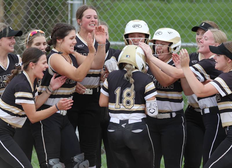 Sycamore's Addison McLaughlin is mobbed by her teammates after hitting a home run during their game against Ottawa Thursday, May 2, 2024, at Sycamore High School.