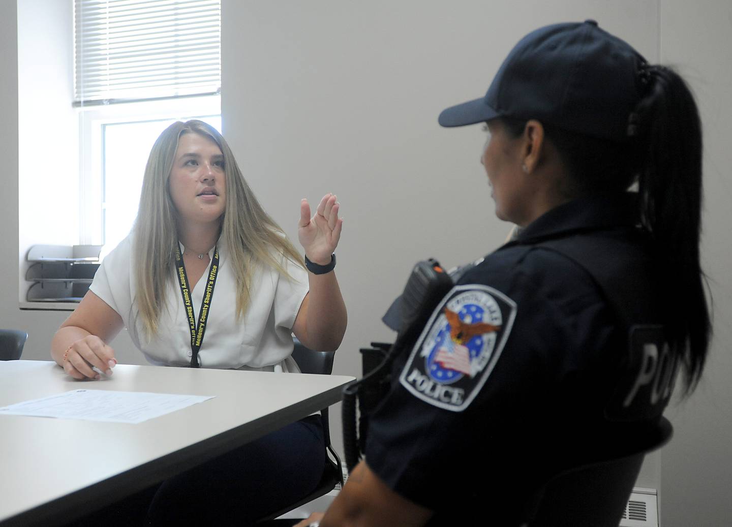 McHenry County Sheriff's Office social worker Taylor Keegan talks with Crystal Lake police officer Ingrid Pinto about a mental health case she has on Thursday, June 16, 2022, in a conference room at the Crystal Lake Police Department. The social workers are part of the sheriff's office new social worker program. Social workers were hired to help police in situations involving mental health crisis. They go out on calls sometimes and follow up in the days, weeks and months that follow to help a person get to the resources they need.