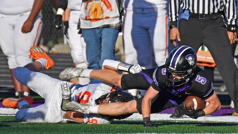 Downers Grove North’s Max Troha (5) lunges for extra yardage after making a sideline catch during a Class 7A quarterfinal game against Lincoln-Way West on November 15, 2025 at Downers Grove North High School in Downers Grove .