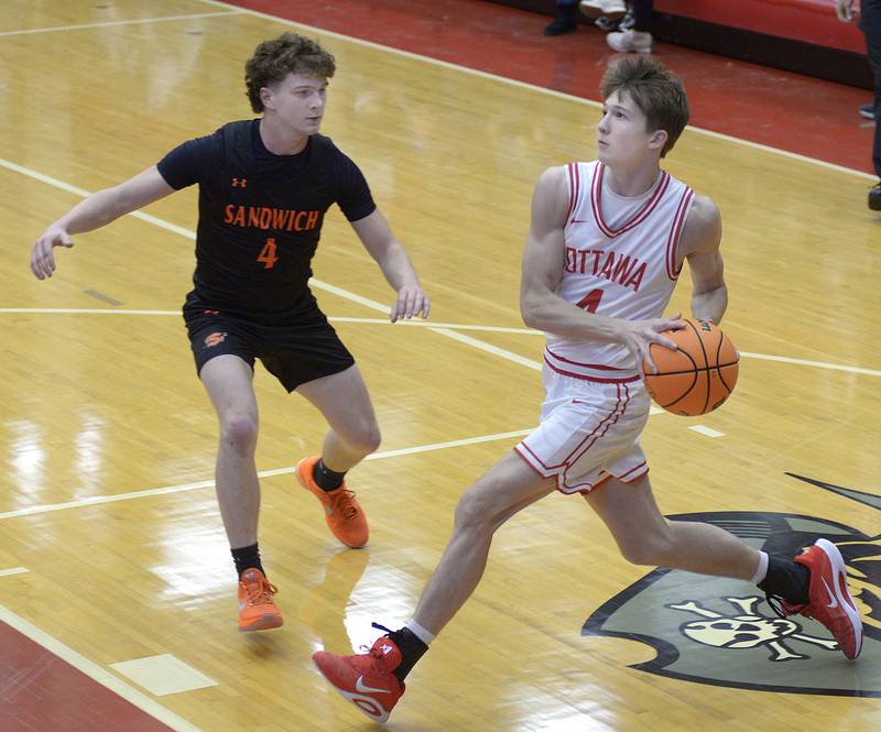 Ottawa’s Blake Schmitz works to drive past Sandwich’s Griffin Somolock in the 1st period Tuesday at Ottawa.