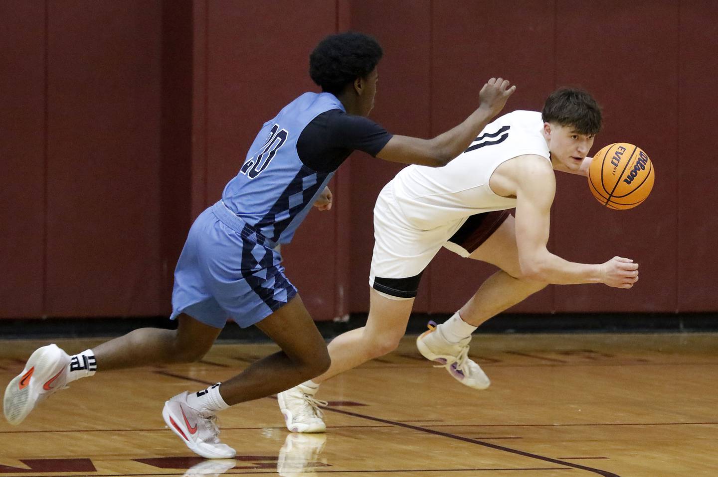 Prairie Ridge's Elijah Loeding (right) brings the ball up the court against Illinois Math & Science Academy's Mofe Suleiman during a IHSA Class 3A Burlington Central Regional quarterfinal boys basketball game on Monday, feb23, 20256, at Prairie Ridge High School in Crystal Lake.