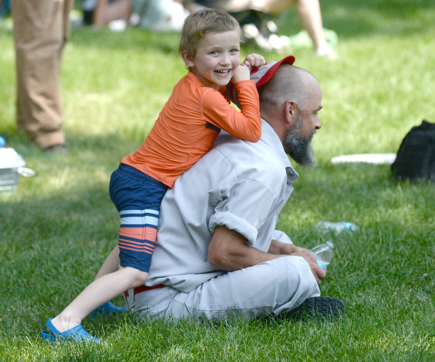 Noah Rogers, 6, of Oregon teases Oregon Ganymede player Mike "T-Bag" Thomas as they watch the Ganymedes' vintage base ball game with the DuPage Plowboys on Saturday, June 3 at the John Deere Historic Site in Grand Detour. Rogers dad is also on the Ganymede team.