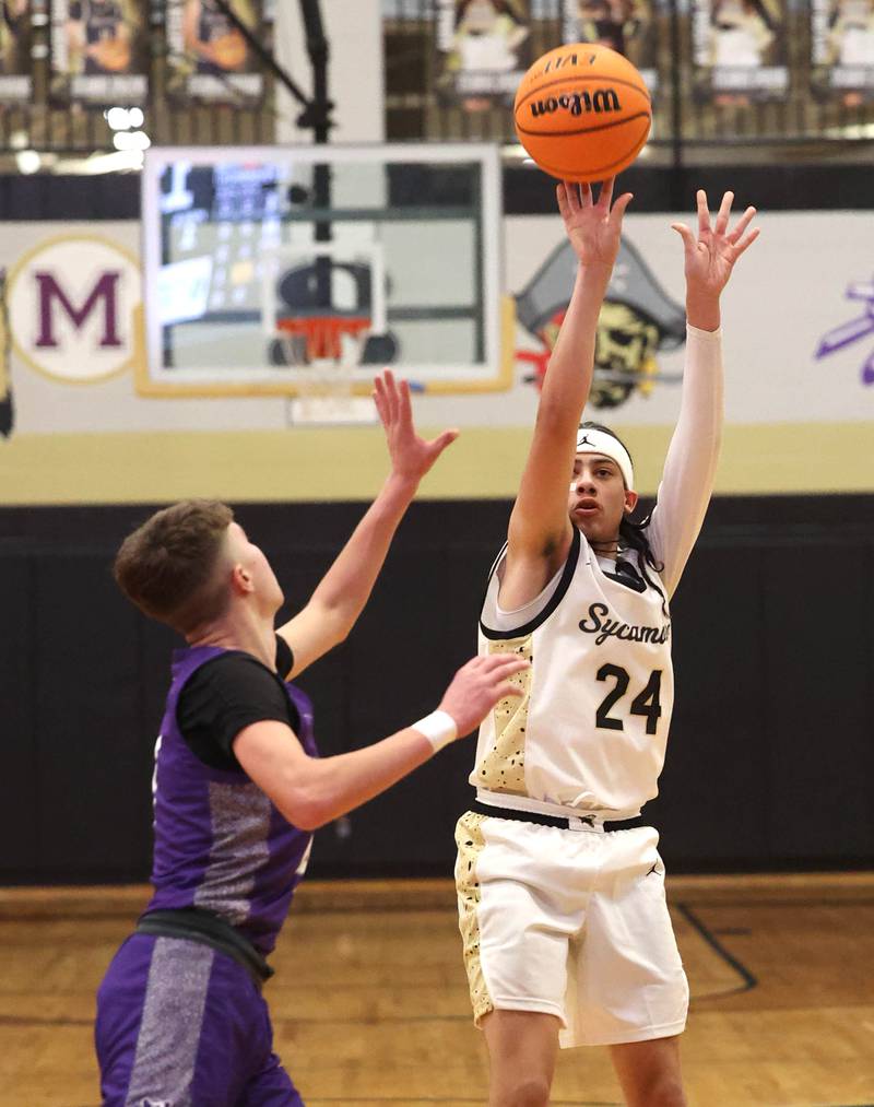 Sycamore's Unique Shaw shoots over Dixon’s Brody Nicklaus during their game Tuesday, Jan. 14, 2025, at Sycamore High School.