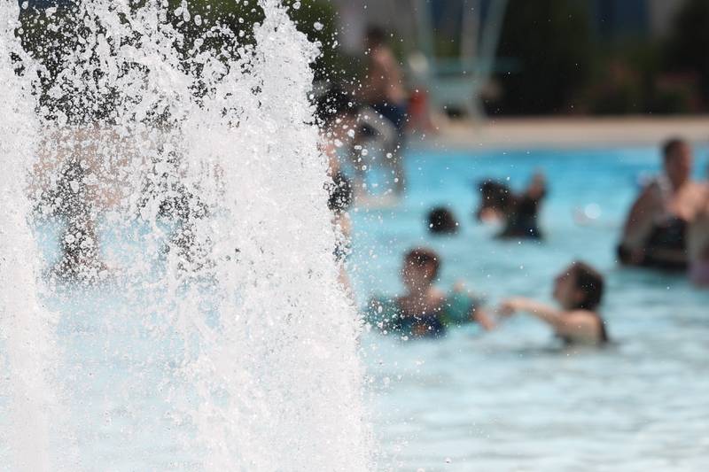 Water sprays as people cool off at Chaney Pool on a hot Tuesday afternoon in Lockport.