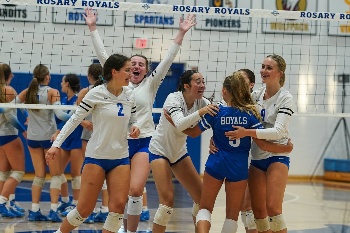 Rosary players celebrate after a score against St. Charles North during a volleyball game at Rosary High School in Aurora on Monday, Aug 25, 2025.