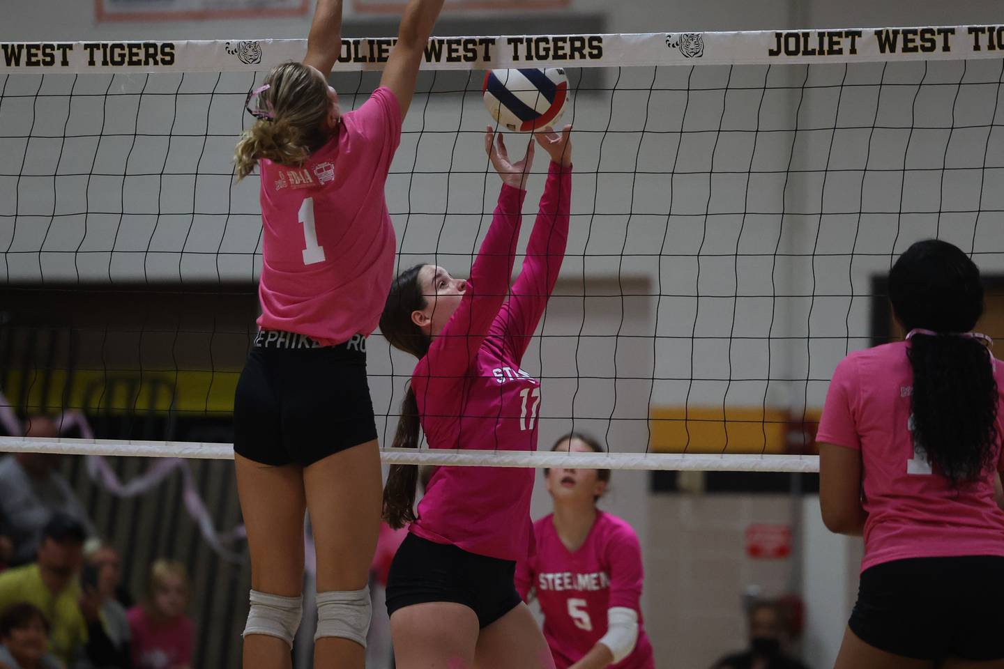 Joliet Central’s Sadie Johnson pushes the ball over against Joliet West in the JTHS Pink Heals match. Tuesday, Oct. 4, 2022, in Joliet.