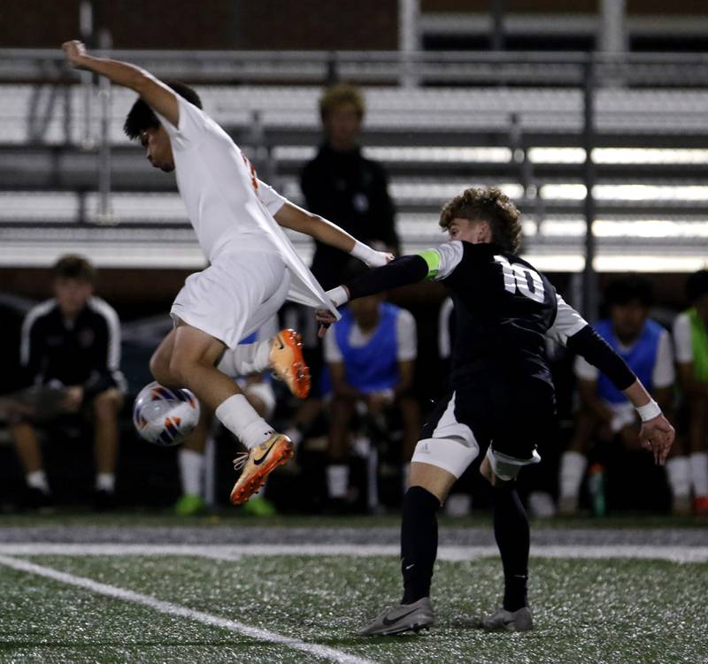 Crystal Lake Central's Joshua Hernandez tries to control the ball as Prairie Ridge's Chase Santucci grabs his jersey during the IHSA Boys Soccer 2A Grayslake Central Sectional semifinal match on Tuesday, Oct. 29, 2024, at Grayslake Central High School.